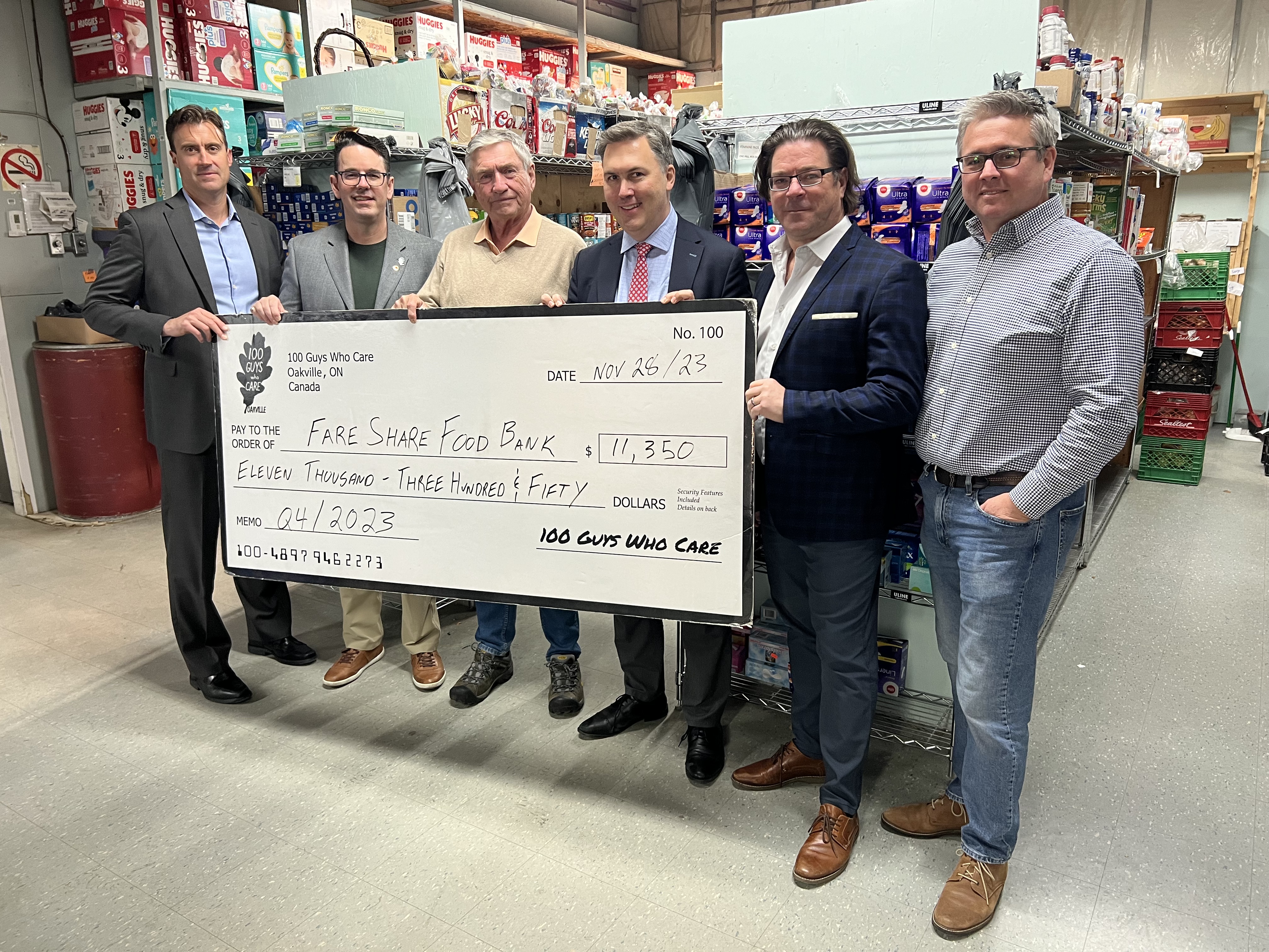 Committee members of 100 Guys Who Care Oakville (Chris Chapman, Ian Pedersen, Jeff Percival, Mike Klink and Chris Foulon) presented the cheque to Fare Share Food Bank volunteer president Steve Rowe. | Oakville News N.M.